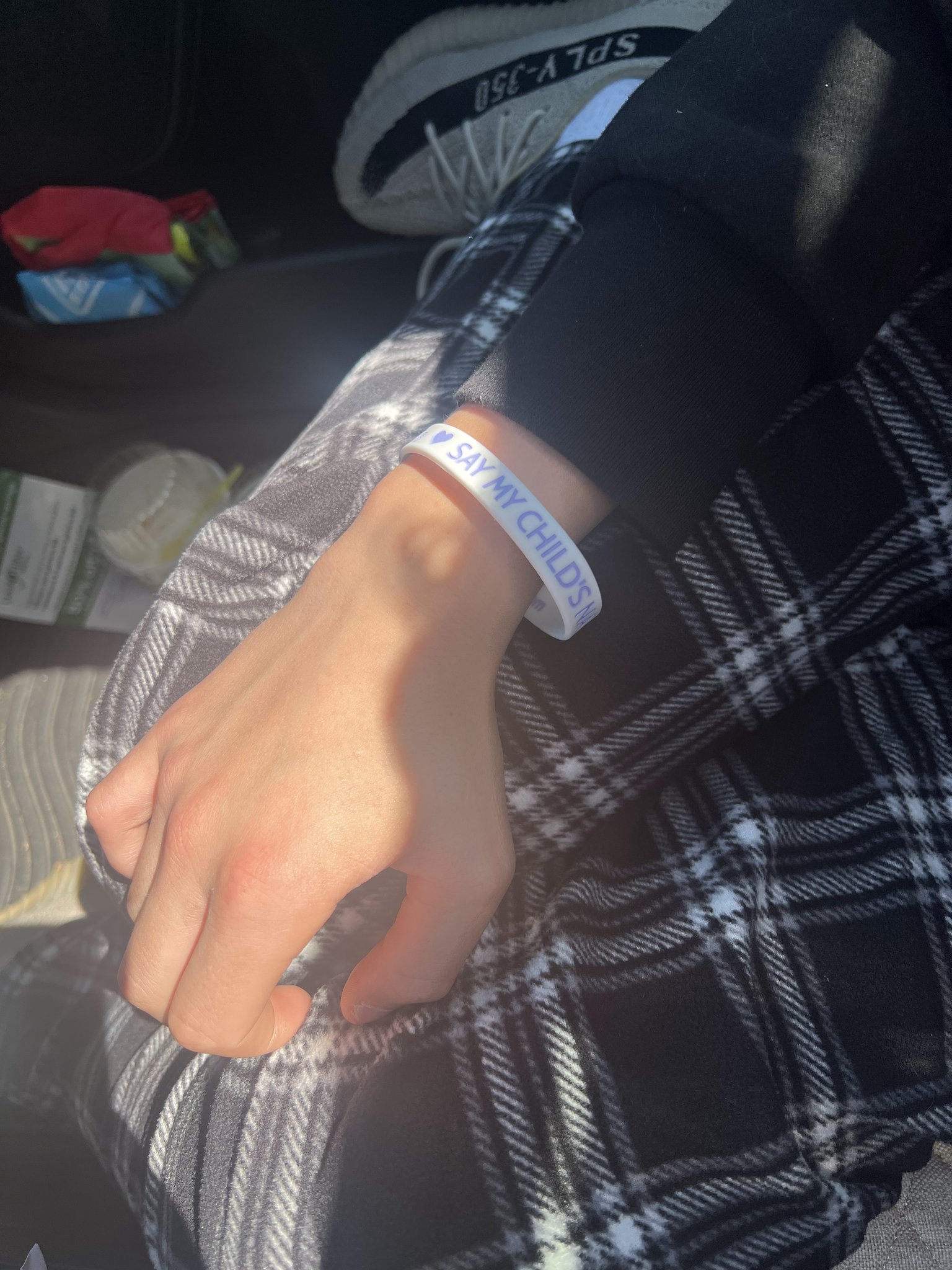 A supporter wearing a Say My Child's Name bracelet