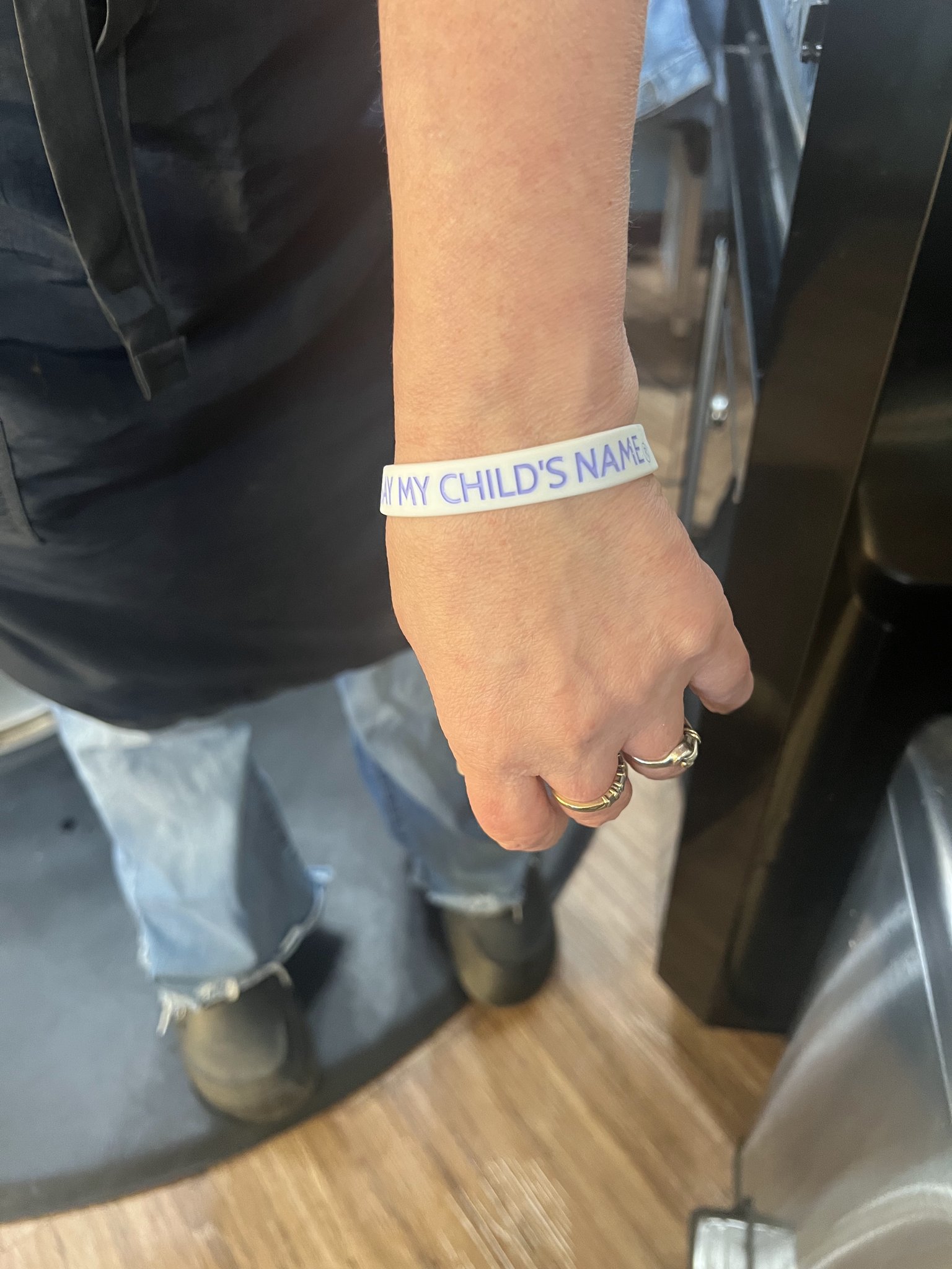 A supporter wearing a Say My Child's Name bracelet